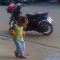 Thai child playing in the street
